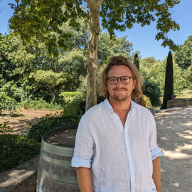 Max smiling in front of a barrel 